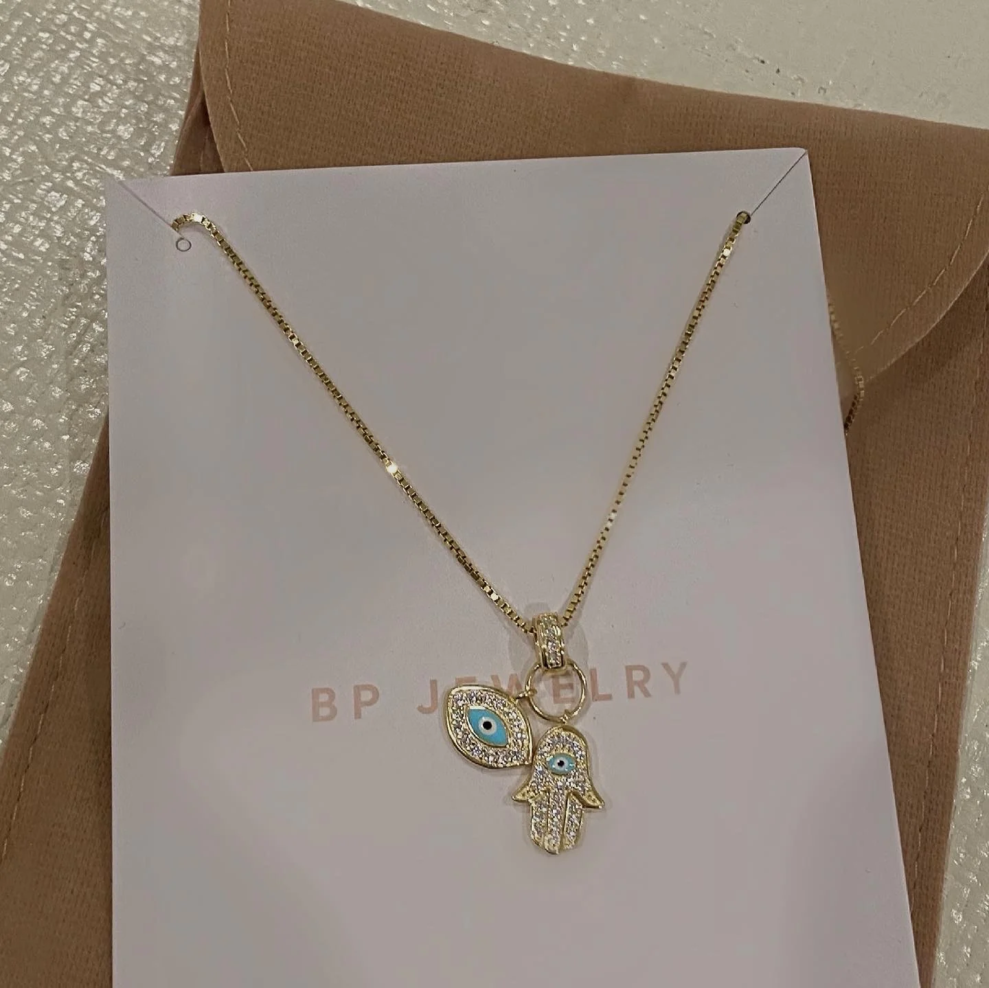 The Gold Evil Eye Hamsa Double Charm Necklace - Image 2